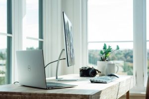 Desktop and laptop sitting on desk photo | Mutual Insurance Testimonials