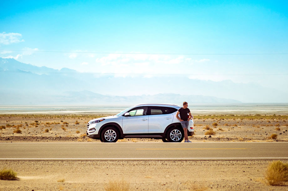 Man standing on side of road with car photo | Mutual Insurance | Auto Insurance